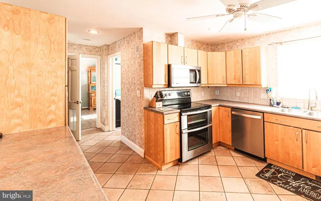 a kitchen with a stove a sink and a refrigerator