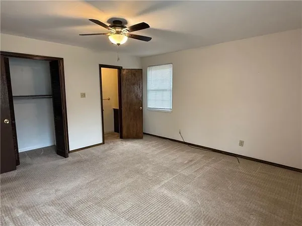 a view of an empty room with a ceiling fan