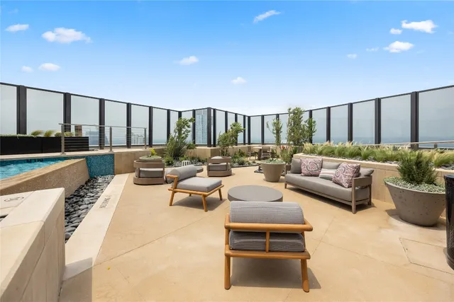 a view of swimming pool with outdoor seating and barbeque oven