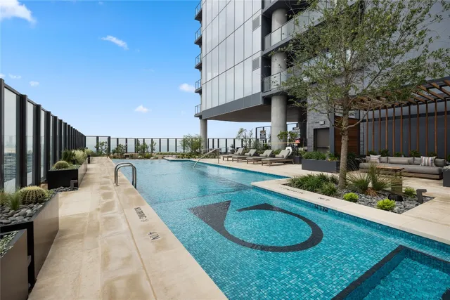 a living room with furniture kitchen view and a table