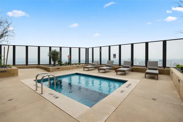 a living room with lots of furniture and a potted plant