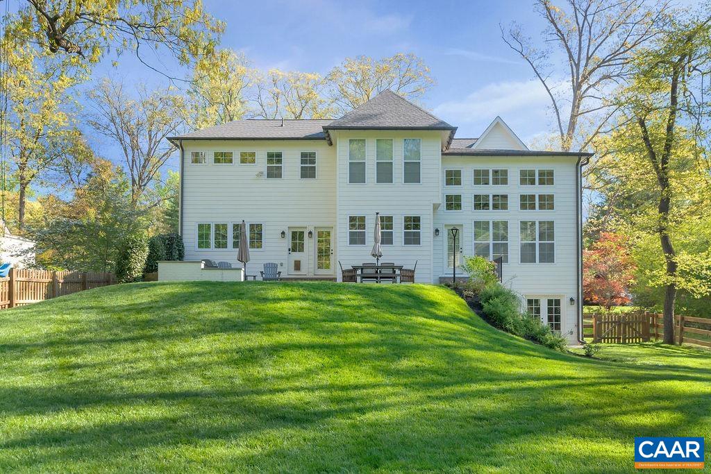 1508 Grove Road Charlottesville, VA 22901 - Photo 49 of 69 a view of a white house with a big yard and potted plants and large trees