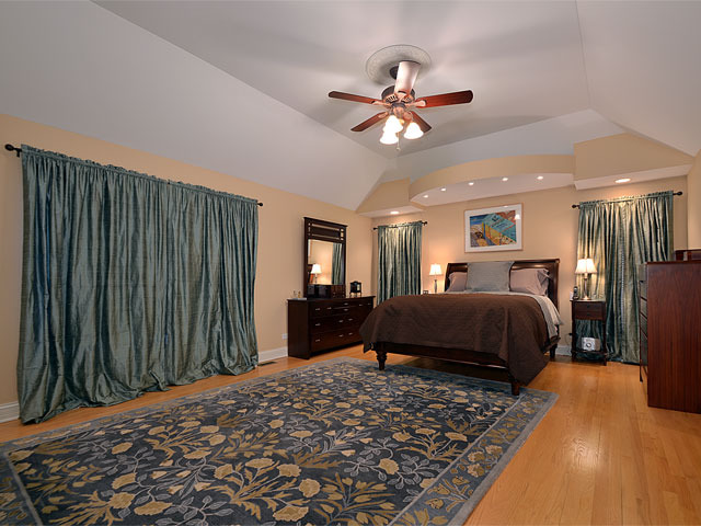 1260 Aberdeen Road Inverness, IL 60067 - Photo 11 of 23 a bedroom with a bed ceiling fan and a wooden floor