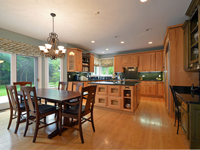 1260 Aberdeen Road Inverness, IL 60067 - Photo 5 of 23 a kitchen with stainless steel appliances granite countertop a kitchen island a stove a table and chairs