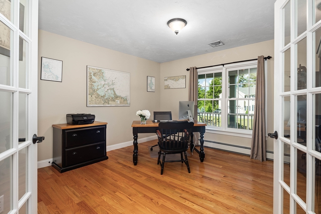 57 Wright's Way Marshfield, MA 02050 - Photo 15 of 35 a living room with furniture and a dining table with wooden floor
