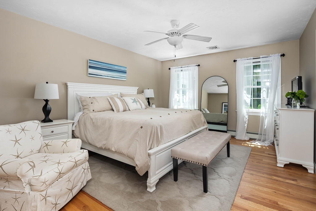 57 Wright's Way Marshfield, MA 02050 - Photo 17 of 35 a spacious bedroom with a bed a couch and chandelier