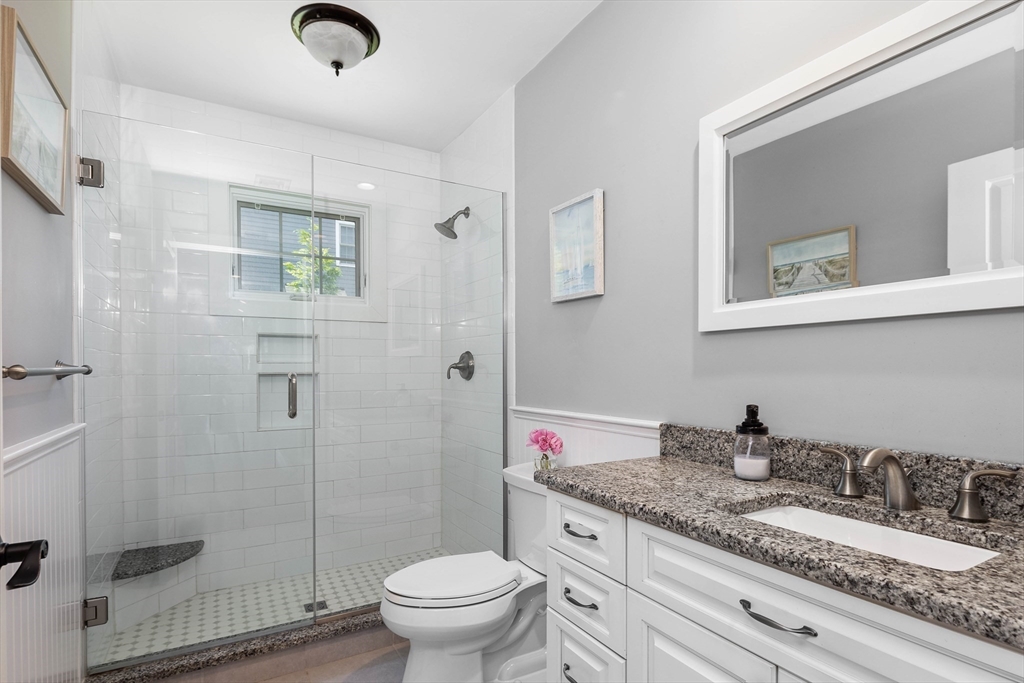 57 Wright's Way Marshfield, MA 02050 - Photo 21 of 35 a bathroom with a granite countertop sink a toilet and shower