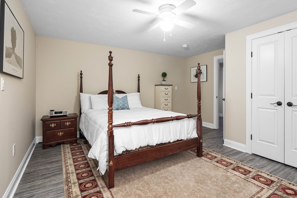 57 Wright's Way Marshfield, MA 02050 - Photo 24 of 35 a bedroom with a bed and a chandelier