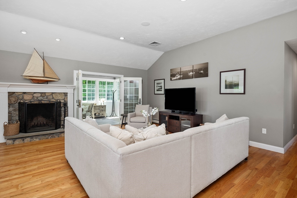 57 Wright's Way Marshfield, MA 02050 - Photo 5 of 35 a living room with furniture a flat screen tv and a fireplace