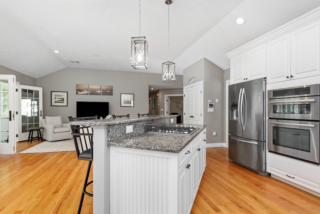 57 Wright's Way Marshfield, MA 02050 - Photo 8 of 35 a kitchen with stainless steel appliances granite countertop a refrigerator a stove top oven a sink dishwasher and a refrigerator with wooden floor