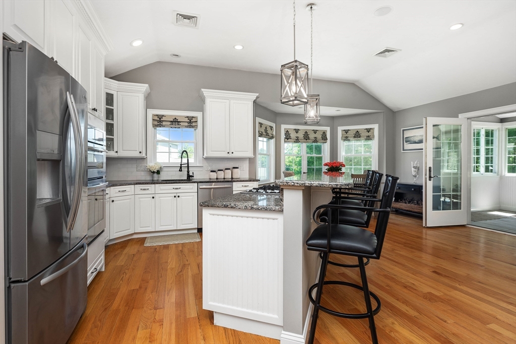 57 Wright's Way Marshfield, MA 02050 - Photo 10 of 35 a kitchen with stainless steel appliances a dining table chairs stove refrigerator and cabinets