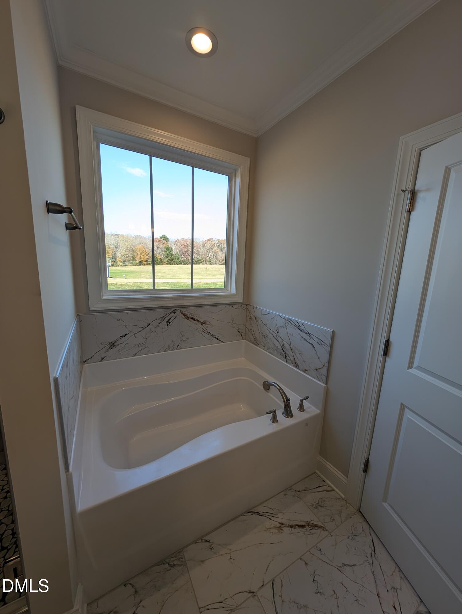 2830 John Lewis Road Burlington, NC 27217 - Photo 30 of 55 a bath tub sitting in a bathroom next to a window