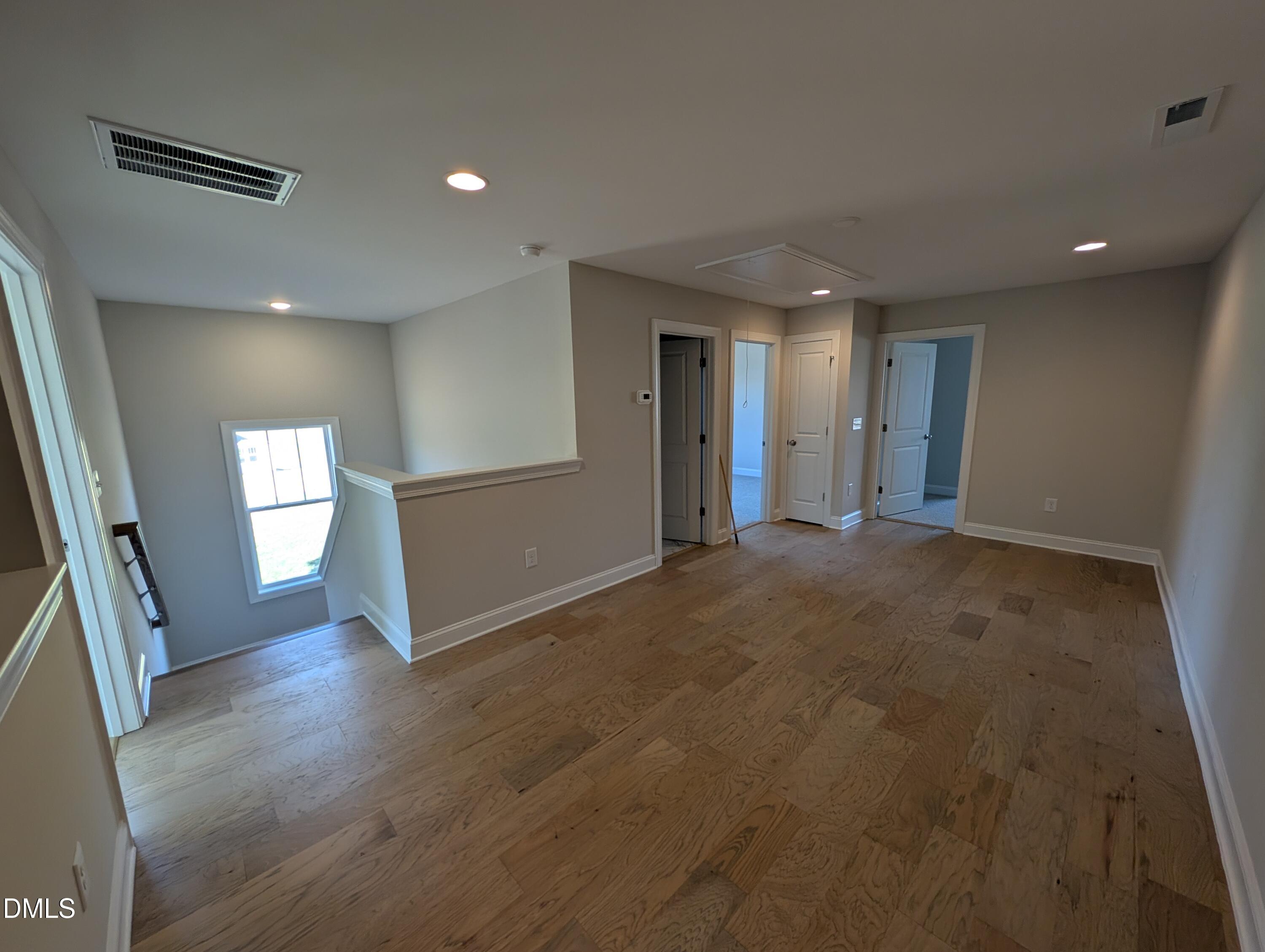 2830 John Lewis Road Burlington, NC 27217 - Photo 38 of 55 an empty room with wooden floor and windows