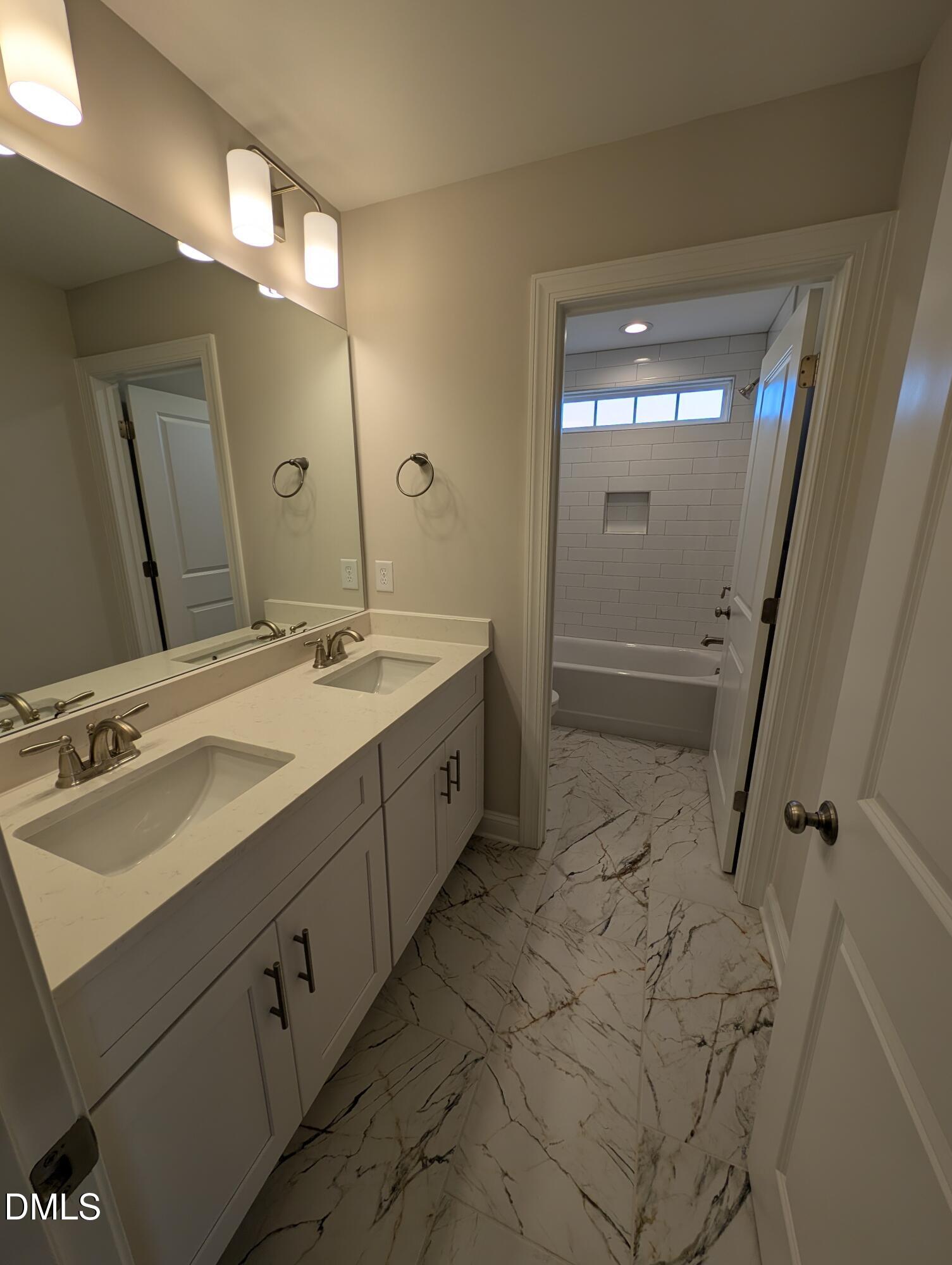 2830 John Lewis Road Burlington, NC 27217 - Photo 39 of 55 a spacious bathroom with a double vanity sink mirror and shower