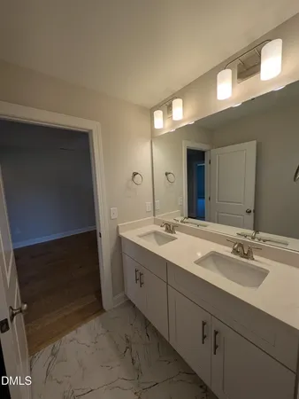 a bathroom with a double vanity sink and a mirror