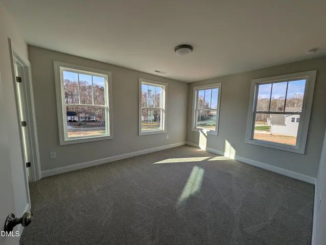 a view of an empty room with windows