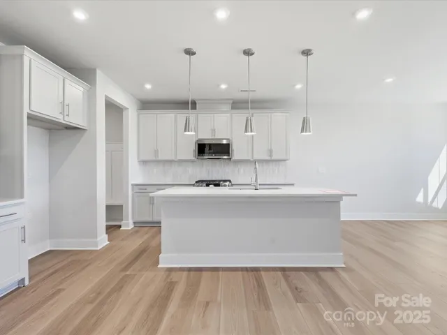 a view of kitchen with wooden floor and window
