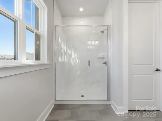 a bathroom with a glass shower door