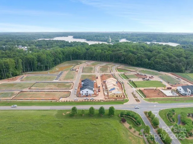 a view of swimming pool with a yard and large trees