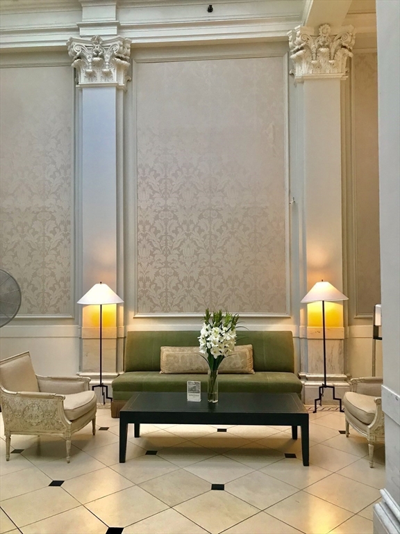 21 Beacon Street, Unit 4Q Boston, MA 02108 - Photo 8 of 10 a living room with furniture and a table