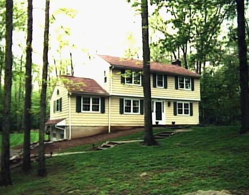 39 Harvey Road Ridgefield, CT 06877 - Photo 1 of 1 a front view of a house with a garden