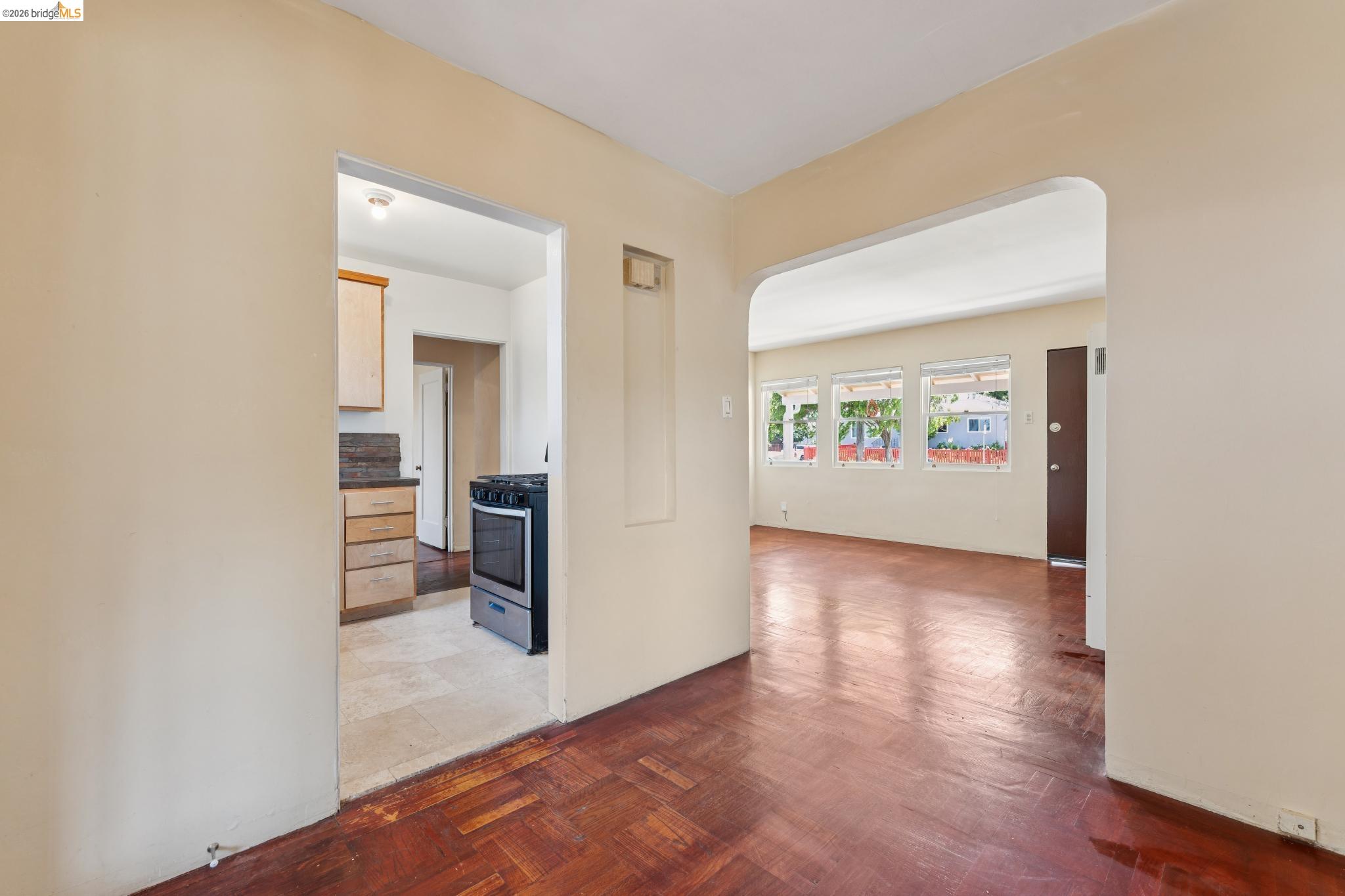 2879 Rheem Avenue Richmond, CA 94804 - Photo 14 of 45 Interior featuring wood-finish flooring, light-toned walls, and an arched doorway
