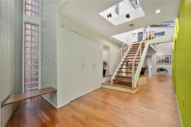 a view of entryway and hall with wooden floor