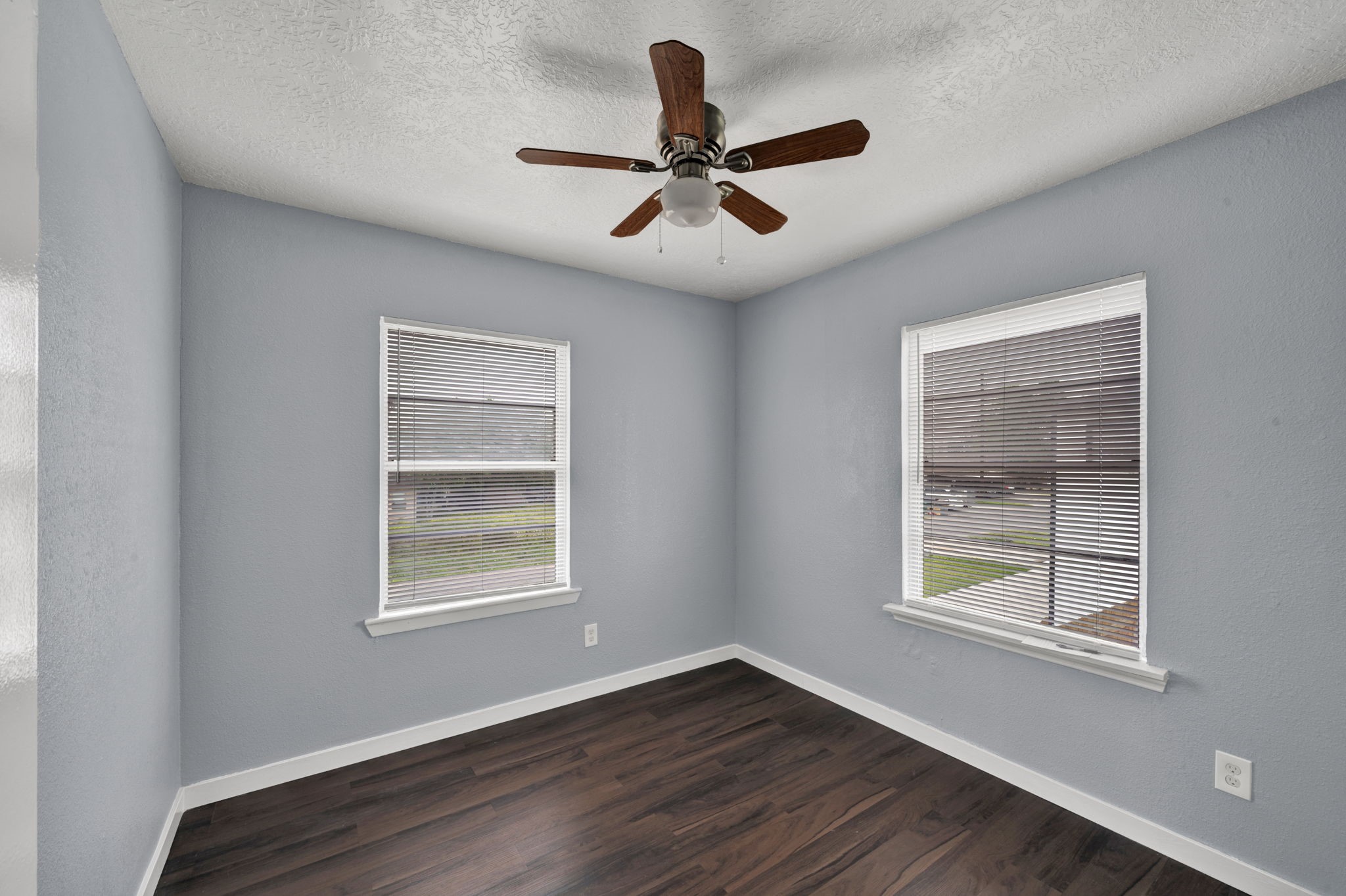 904 Beverly Avenue, Unit 6 Pasadena, TX 77506 - Photo 7 of 32 a view of an empty room with wooden floor and a window