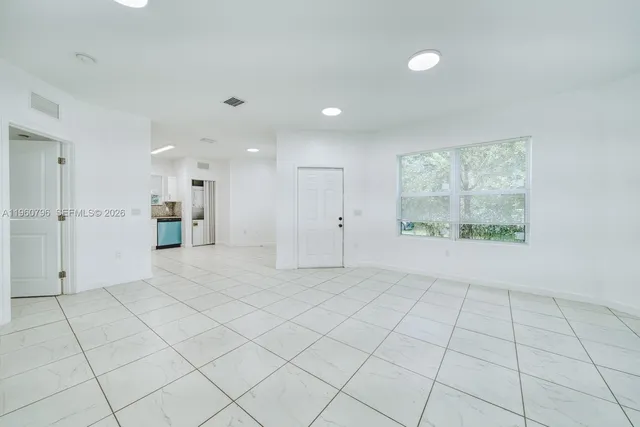 a view of an empty room and a window