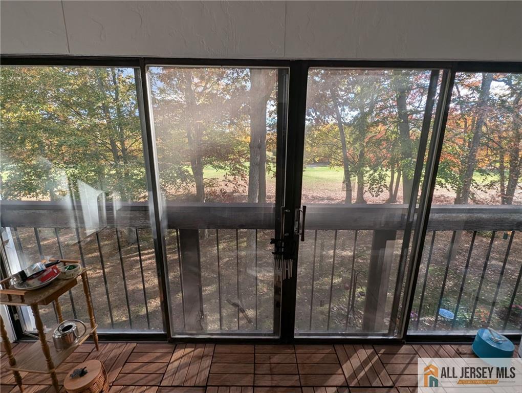 277 Cross Drive, Unit 2E Monroe Township, NJ 08831 - Photo 3 of 10 a view of a porch with a door and a couch