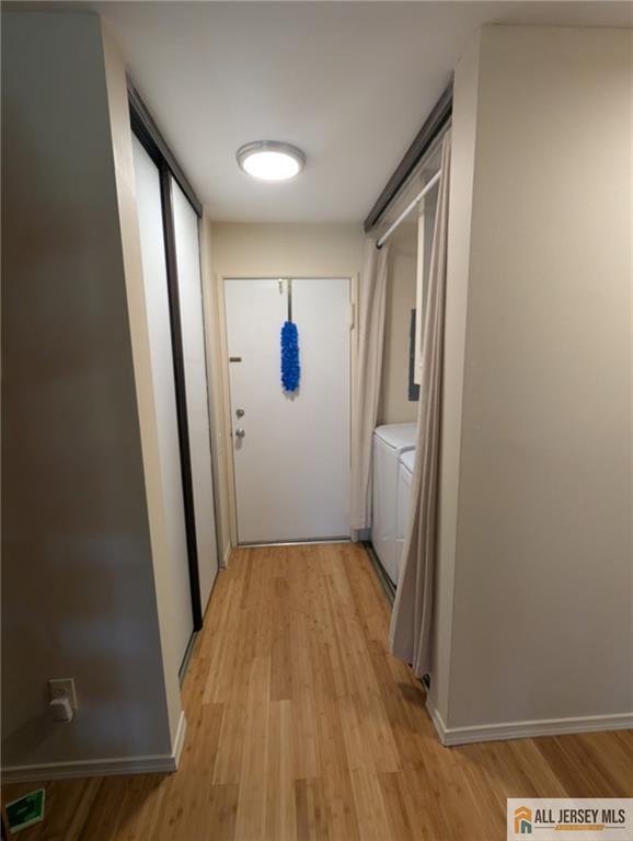 277 Cross Drive, Unit 2E Monroe Township, NJ 08831 - Photo 5 of 10 a view of a hallway with wooden floor and a bathroom