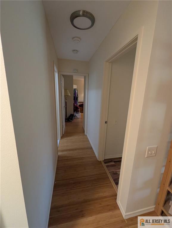 277 Cross Drive, Unit 2E Monroe Township, NJ 08831 - Photo 7 of 10 a view of a hallway with wooden floor and staircase