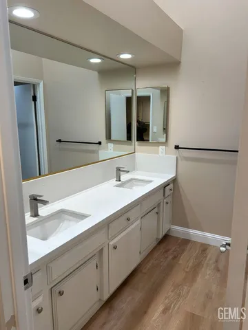 a spacious bathroom with a sink and a mirror