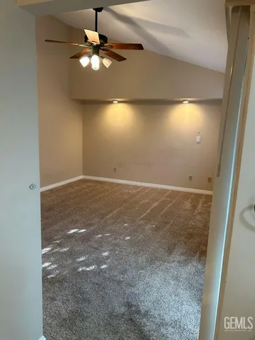 en empty room with window and a ceiling fan