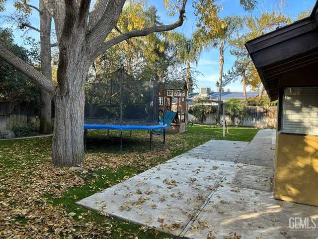 a front view of a house with a tree