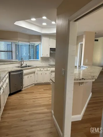 a large kitchen with cabinets and wooden floor