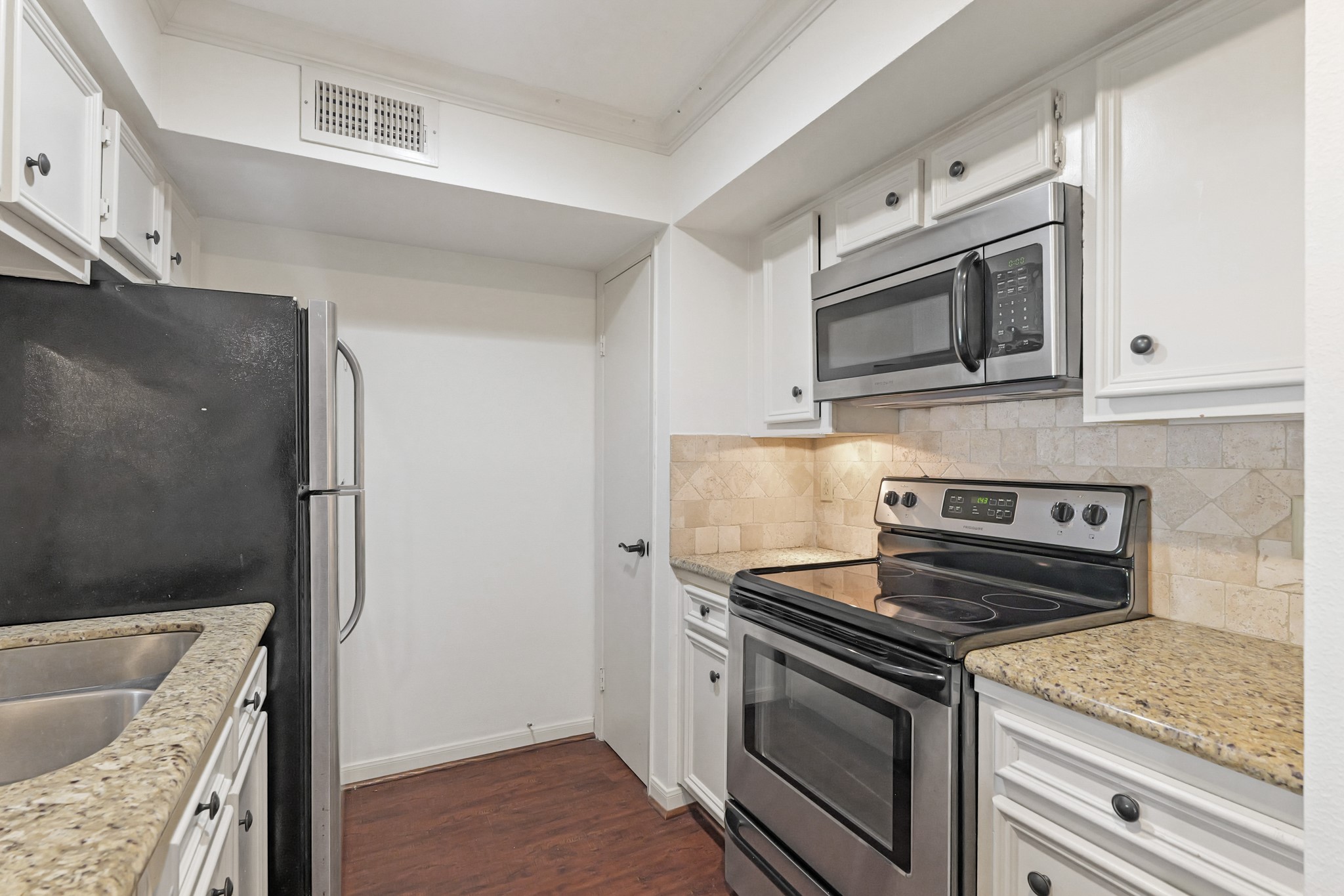 2800 Jeanetta Street, Unit 1402 Houston, TX 77063 - Photo 14 of 29 a kitchen with granite countertop cabinets stainless steel appliances and wooden floor