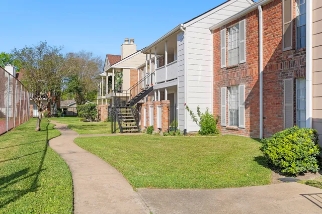 a front view of a building with a garden