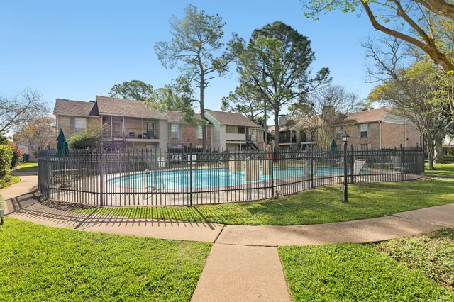 a view of a house with a backyard and a garden