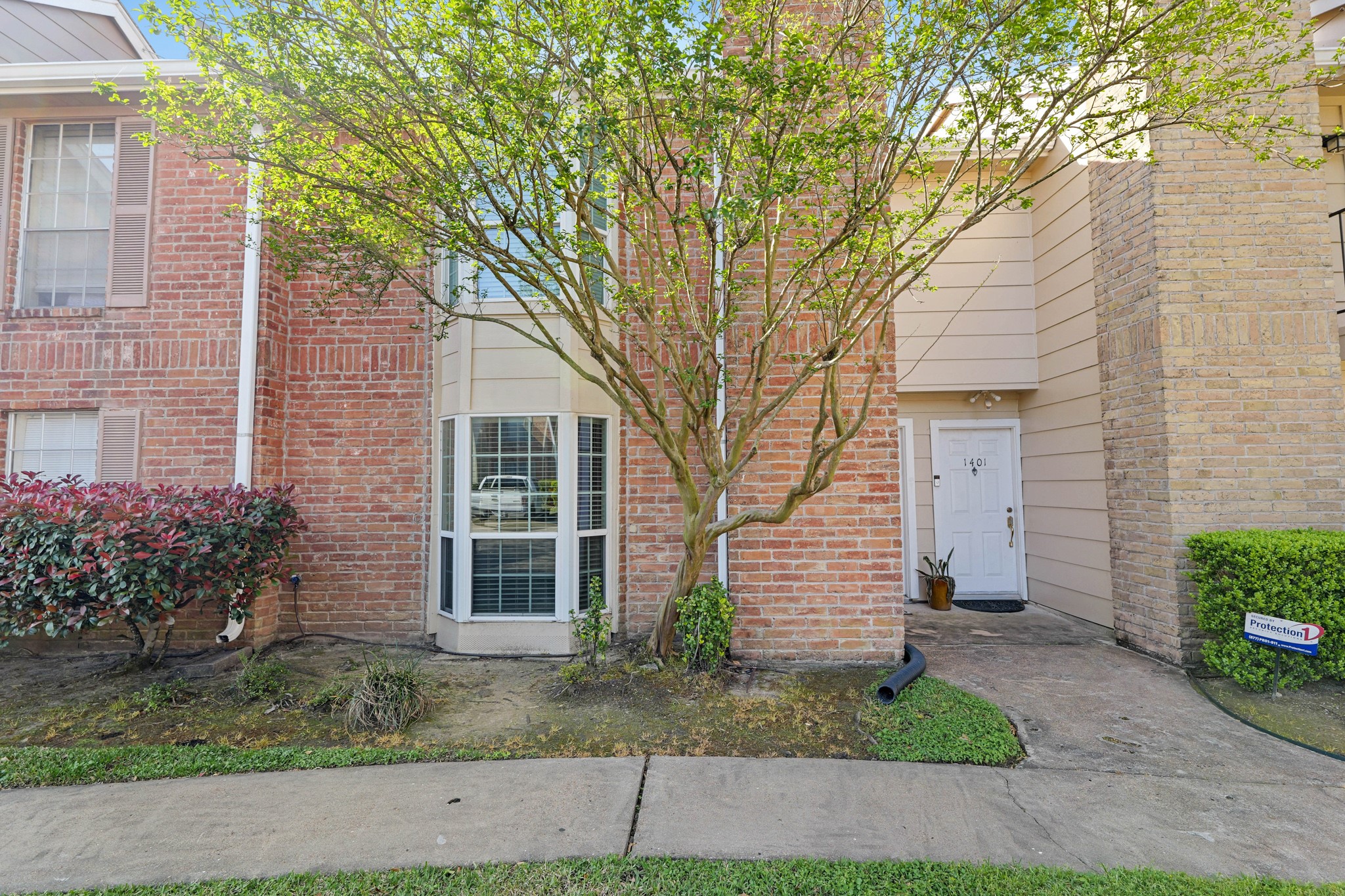 2800 Jeanetta Street, Unit 1402 Houston, TX 77063 - Photo 3 of 29 a front view of a house with garden