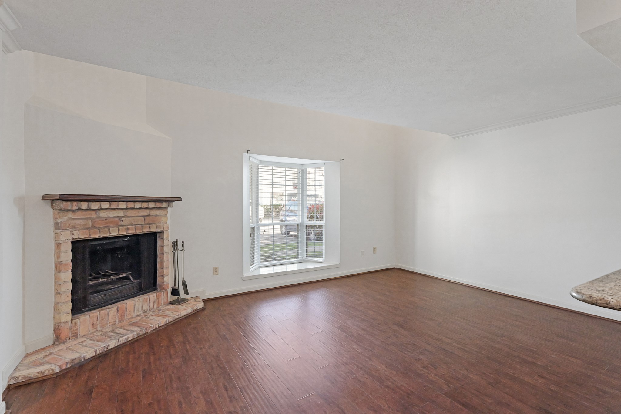 2800 Jeanetta Street, Unit 1402 Houston, TX 77063 - Photo 6 of 29 an empty room with wooden floor fireplace and windows