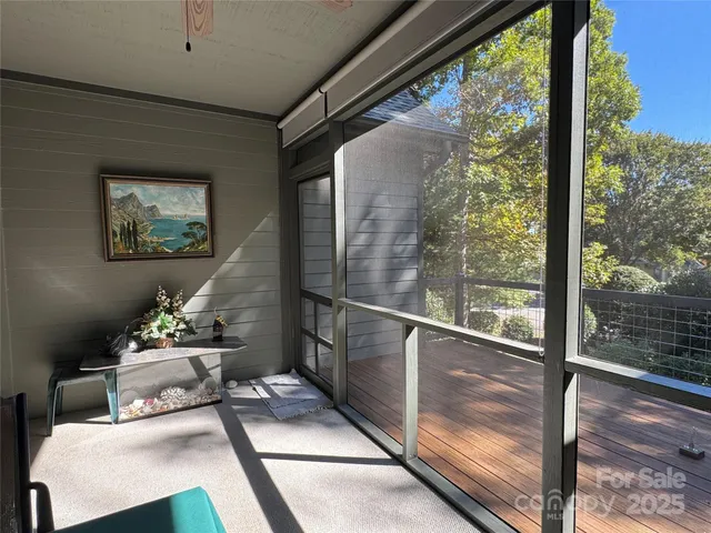 a balcony with wooden floor and table