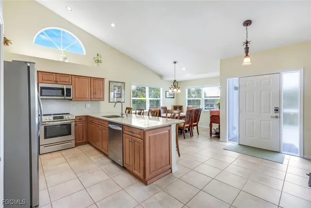 a kitchen with stainless steel appliances granite countertop a stove top oven a sink a counter top space and cabinets
