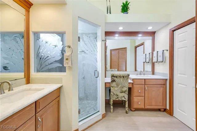 a bathroom with a double vanity sink mirror and shower