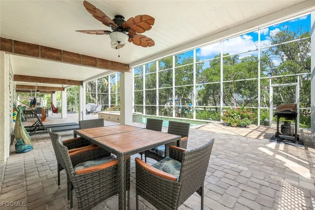 a dining room with furniture a chandelier and a rug