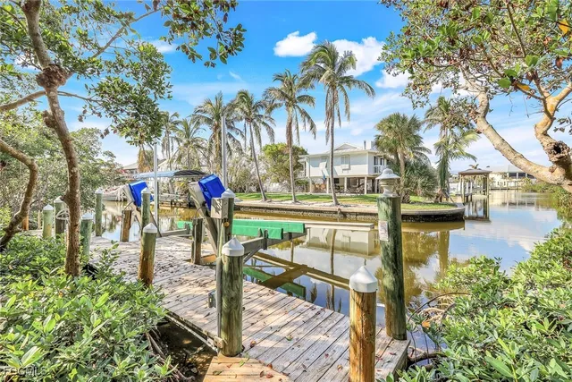 a view of a lake with a bench and trees around