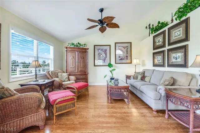 a living room with furniture a ceiling fan and a window