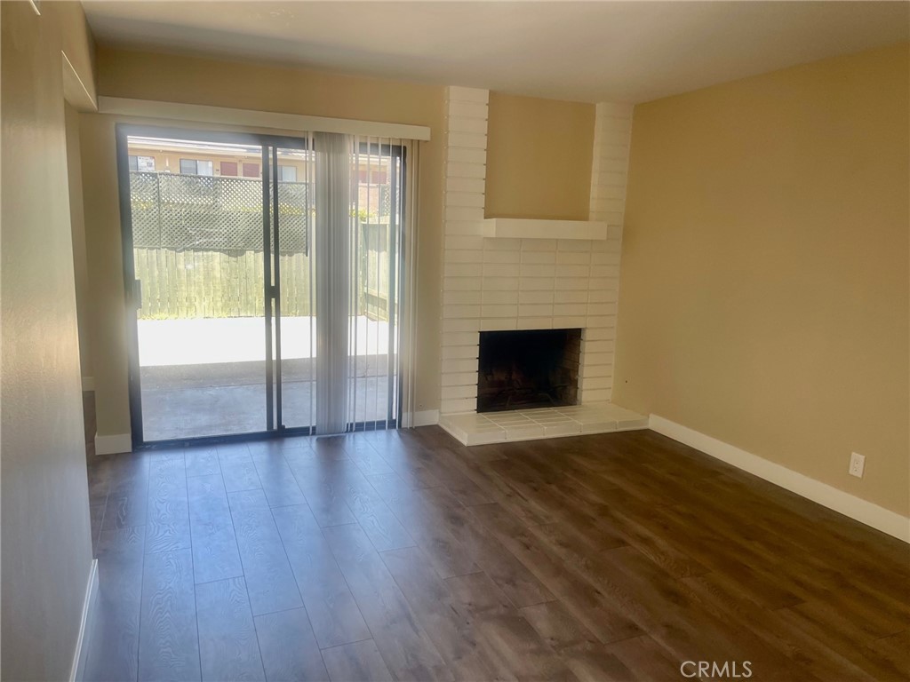 2447 Elden Avenue, Unit C2 Costa Mesa, CA 92627 - Photo 2 of 10 a view of an empty room with wooden floor and a window