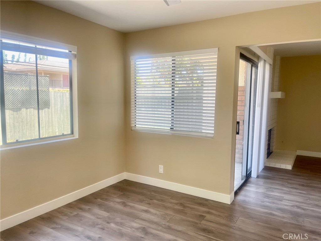 2447 Elden Avenue, Unit C2 Costa Mesa, CA 92627 - Photo 5 of 10 a view of an empty room with wooden floor and a window