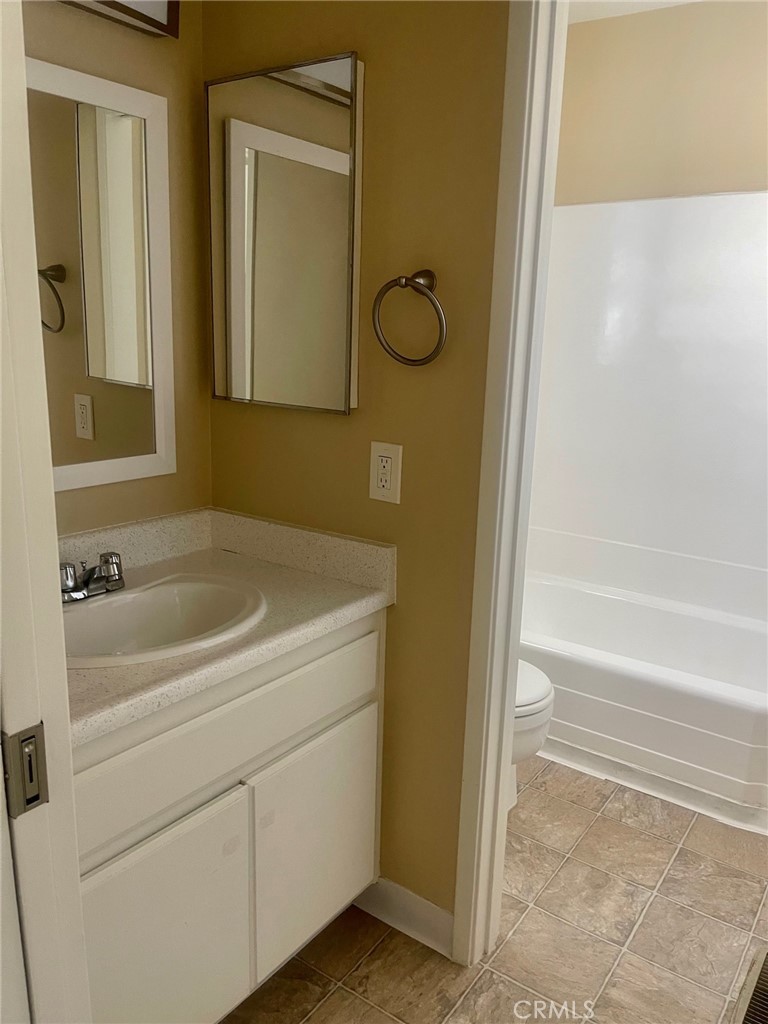 2447 Elden Avenue, Unit C2 Costa Mesa, CA 92627 - Photo 7 of 10 a bathroom with a tub and a shower